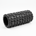 High-density black foam roller on white background